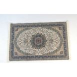 Iranian Isfahan style rug, cream field centred with a medallion within a blue border, size approx.