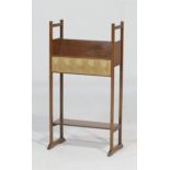 Edwardian mahogany bookstand, circa 1905, in the Arts and Crafts style, with a fabric inset panel,