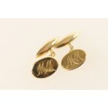 Pair of 18ct gold cufflinks, oval and torpedo form united by chain links, the ovals inscribed with