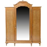 Italian satinwood and chestnut breakfront wardrobe, 20th Century, having a an olive leaf and