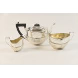 George V silver bachelor's three piece tea service, Birmingham 1919, comprising teapot, sugar