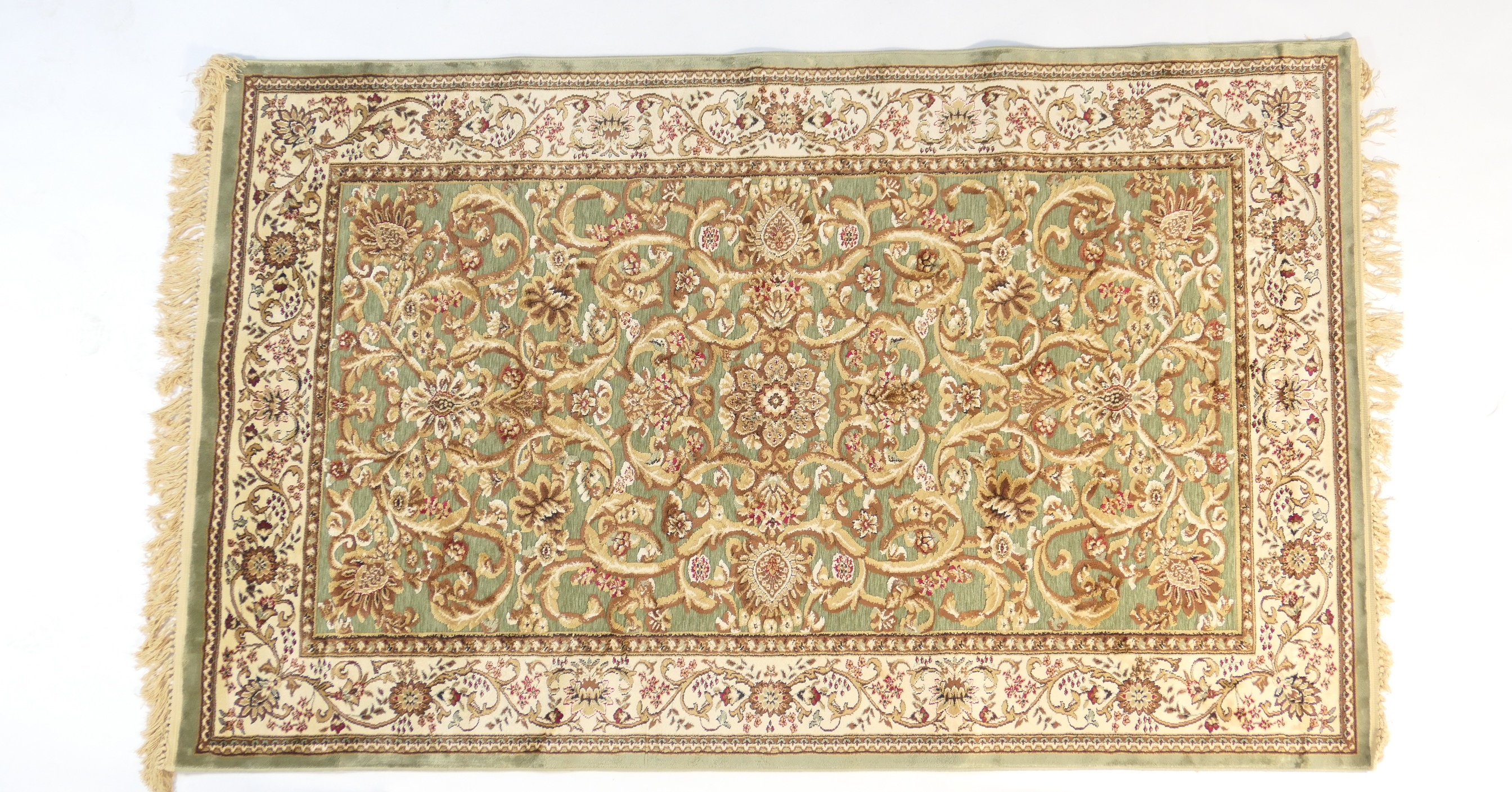 Turkish 'Silkway' rug, green field dispersed with brown flowers and foliage within a fawn border,
