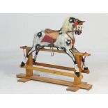 Dapple grey rocking horse, by Collinson of Liverpool, complete with brown corded fabric saddle and