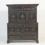 Carved oak parlour cabinet (made up), the top having two long opening doors over three lozenge