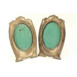 Pair of George V silver photograph frames, Birmingham 1921, shaped oval form bordered with