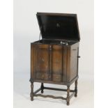 Itonia oak cabinet gramophone, with two doors to the front revealing a sound grille, with a drawer