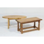 Oak coffee table in the style of Mouseman, the adzed rectangular top supported on tapered