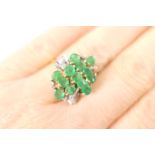 Emerald and diamond cluster ring, set with 13 round cut emeralds, total weight estimated as