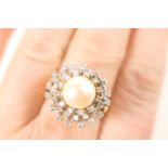 Pearl and diamond cluster ring, the central pearl of approx. 9mm diameter, bordered with 44 small