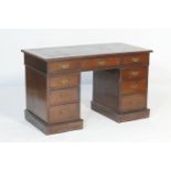 Edwardian mahogany twin pedestal desk, the top with leather inset over a configuration of nine