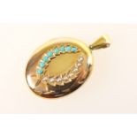 Victorian yellow metal oval picture locket, circa 1890, set with a laurel wreath inset with