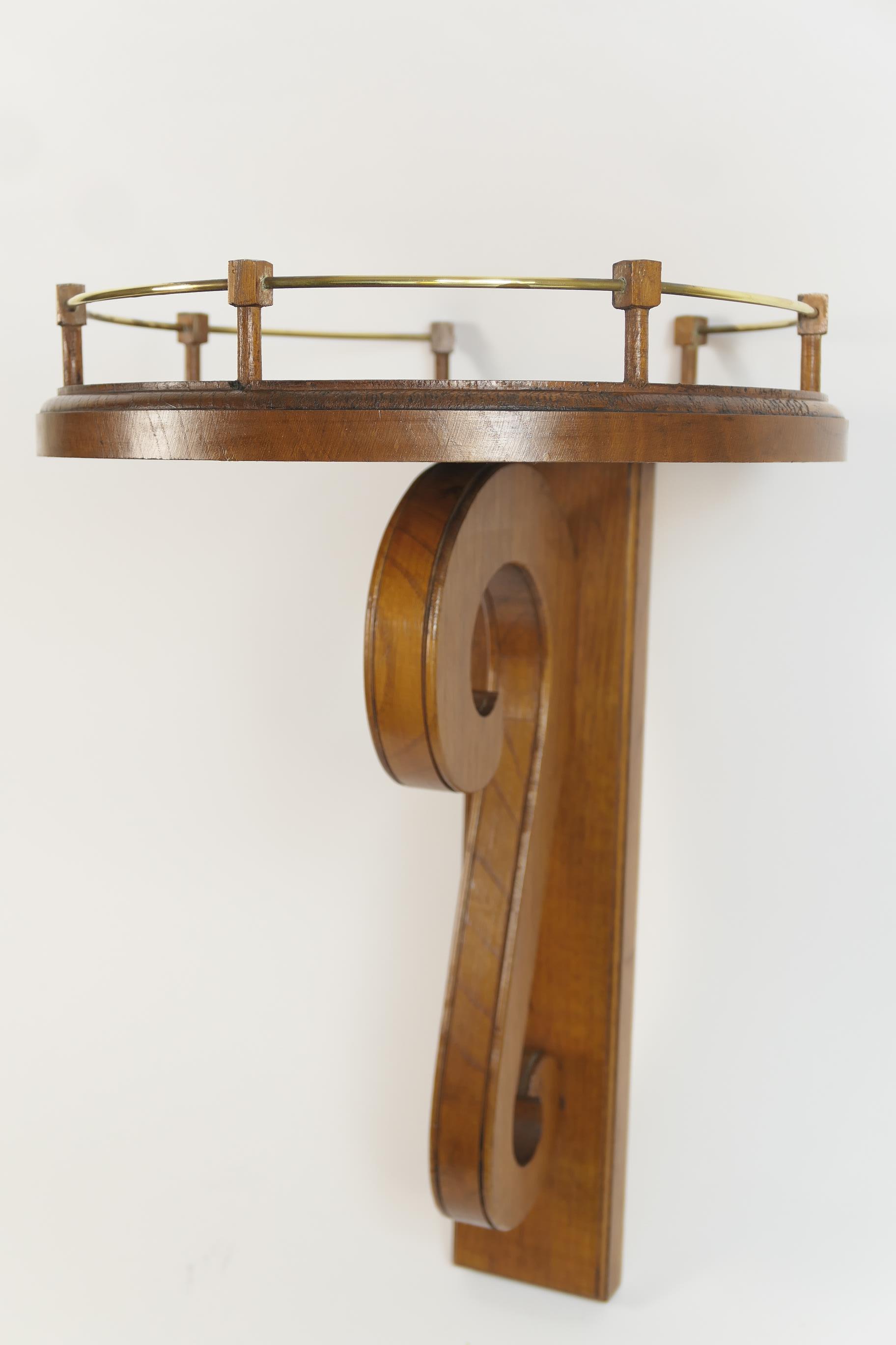Edwardian oak wall bracket, the unusual circular platform with a wirework gallery supported on an