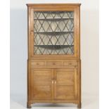 Oak freestanding corner display cabinet, circa 1830, the top having a single lozenge glazed door