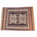 Kazakh woollen rug, blue field with two medallions in sky blue and fawn, within terracotta and
