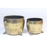 Two similar brass log or coal bins, each of circular form with lions mask ring handles, raised on