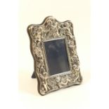 Modern silver photograph frame, Sheffield 1987, shaped rectangular form embossed with winged