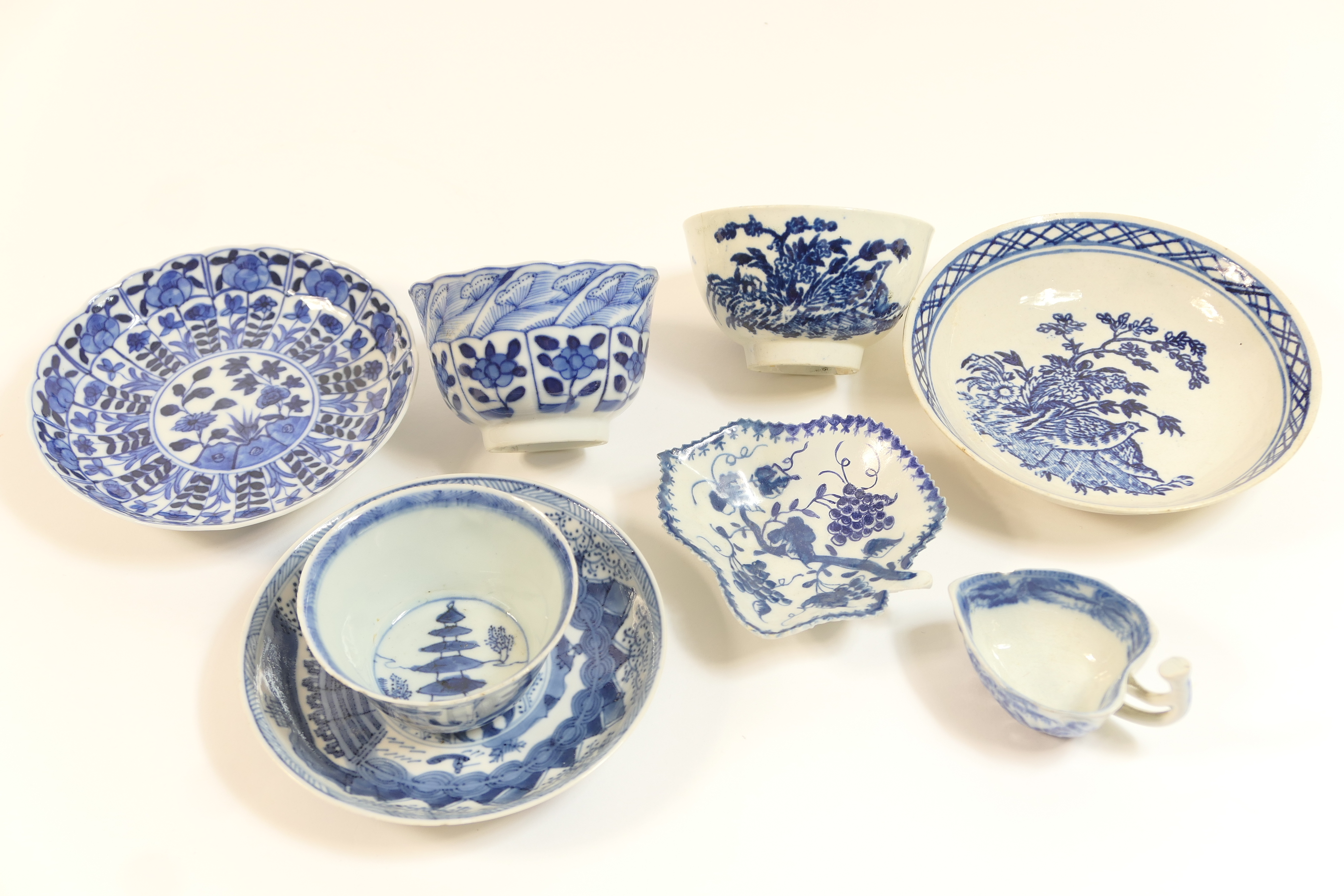 Caughley blue and white printed tea bowl and saucer, in the quail pattern, circa 1780; also a