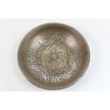 Cairo ware bronze and silver inlaid circular bowl, circa 1900, worked with calligraphic reserves,