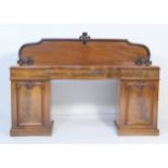 Victorian mahogany twin pedestal sideboard, circa 1870, having a moulded panel back over a