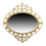 Late Victorian gilt overmantel mirror, in the Adam style, circa 1890, oval bevelled glass plate