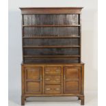 Oak Welsh dresser, early 19th Century, having a boarded plate rack over a base centred with three