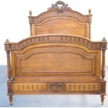 French carved oak double bed in Louis XV style, the arched headboard surmounted with a carved