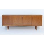 Gunni Omann (for Axel Christensen, Denmark), teak sideboard, having four sliding doors opening to