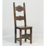 Continental walnut chair, first half 18th Century, the back surmounted with figural terminals and