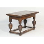 Flemish oak parlour table, 18th or 19th Century, the rectangular top with pull out leaves, supported