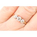 Diamond three stone ring, central brilliant cut stone of approx. 0.4ct, flanked by slightly