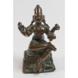 South Indian bronze figure of a four armed deity, 19th Century or earlier, seated holding