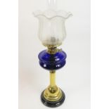 Victorian pedestal oil lamp, with an etched tulip bowl over a blue glass tank and brass reeded