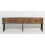 Oak low dresser, circa 1700-20, two plank top over three double moulded panel drawers with