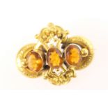 Victorian brooch, circa 1870, set with three oval cut citrines, within a gold coloured hollow