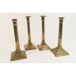 Pair of late Georgian brass column candlesticks, circa 1800-20, with fluted columns over a stepped