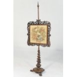 William IV rosewood pole screen, circa 1835, having a fretwork bordered gross-point needlework