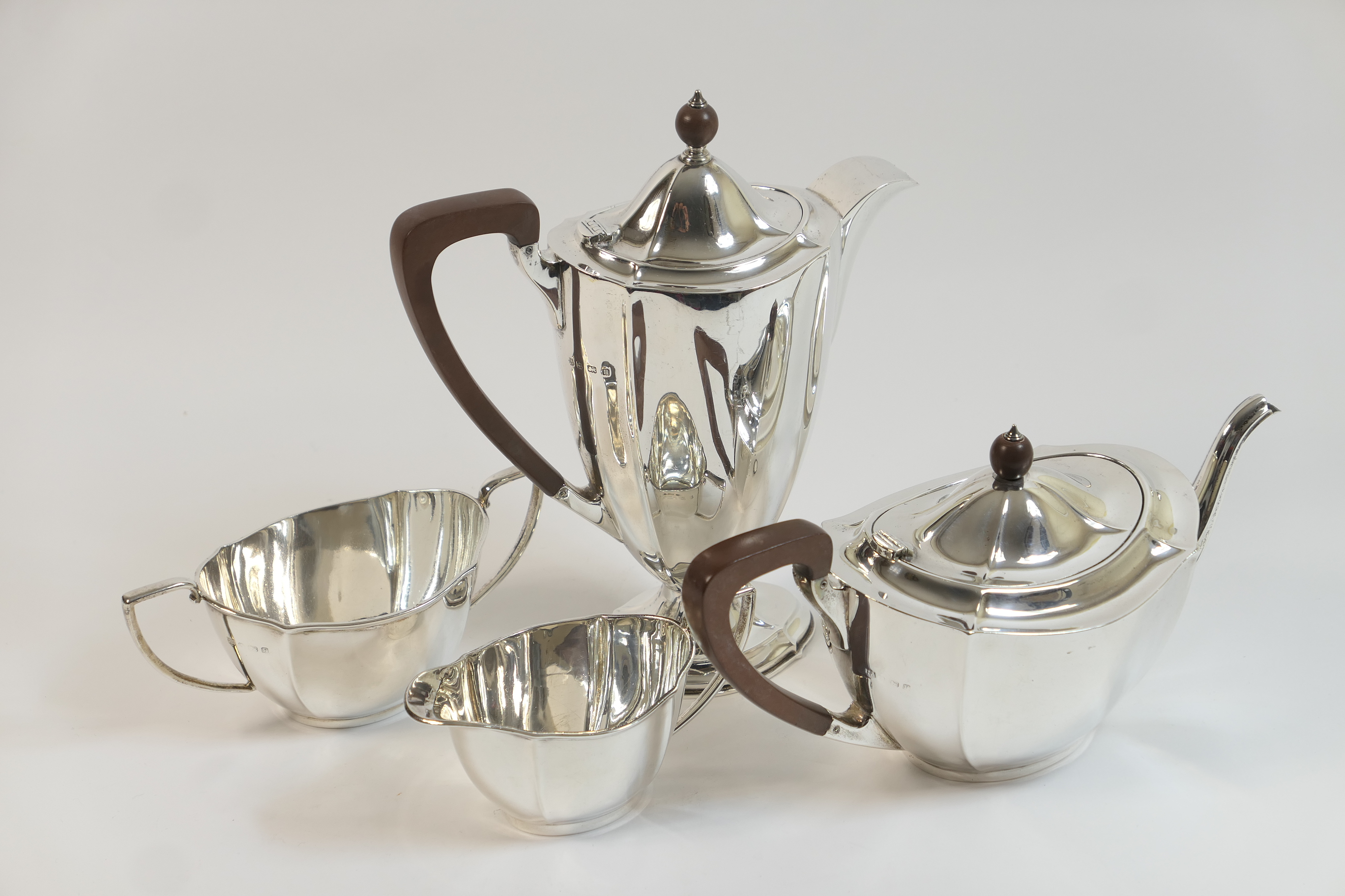 George V silver four piece tea service, Birmingham 1931/32, comprising teapot and footed hot water