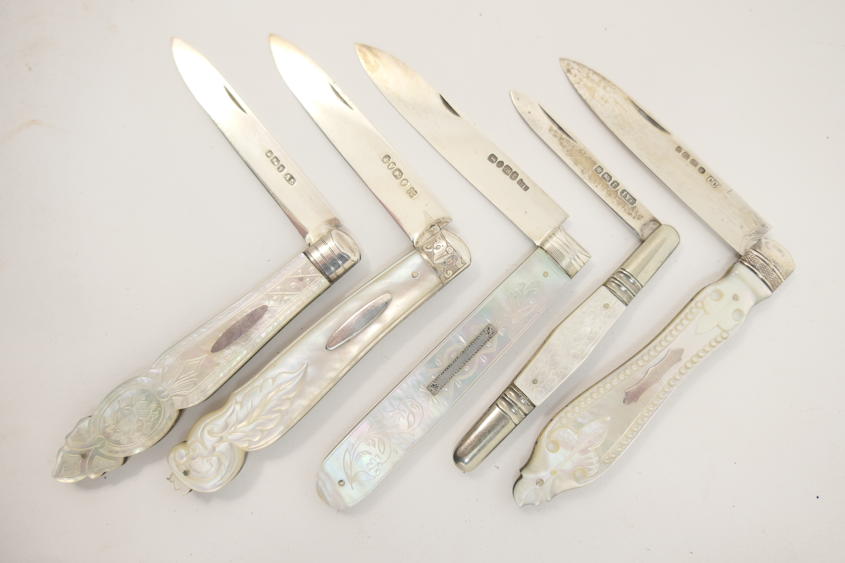 Five Victorian and Edwardian silver and mother of pearl folding fruit knives, including an example