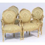 Set of four French giltwood fauteuils, each having a cameo shaped upholstered back surmounted with a