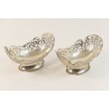 Pair of George V silver bonbon dishes, London 1927, pierced boat shape raised on a lobed trumpet