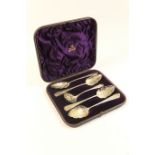 Cased set of Victorian re-worked and gilded fruit spoons and sifter, comprising four Georgian
