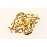 Victorian citrine brooch, circa 1860, of scrolling lozenge form centred with an oval cut stone,