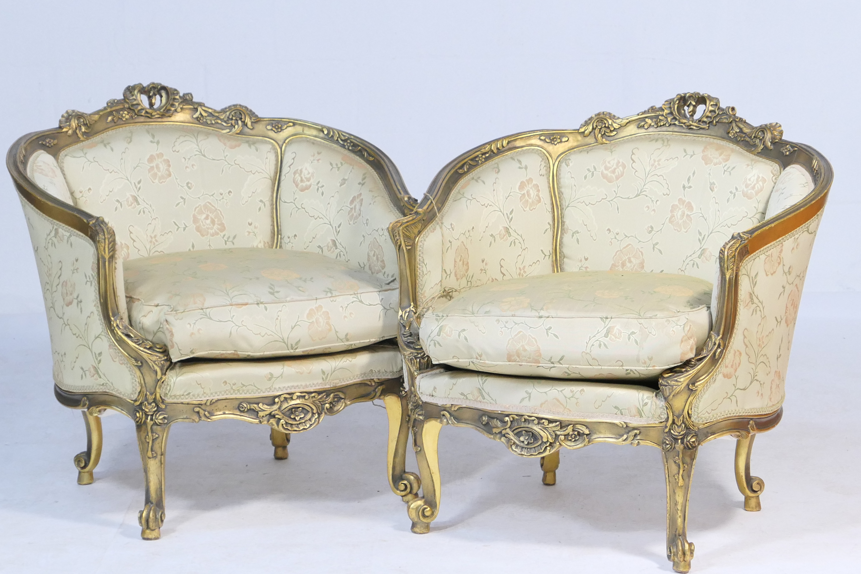 Pair of Italian giltwood and upholstered tub chairs, each in Baroque style with upholstered panelled