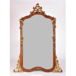 A Mirror, mahogany frame with gilt wood carvings "Vegetalist elements", bevelled mirror, Italian,