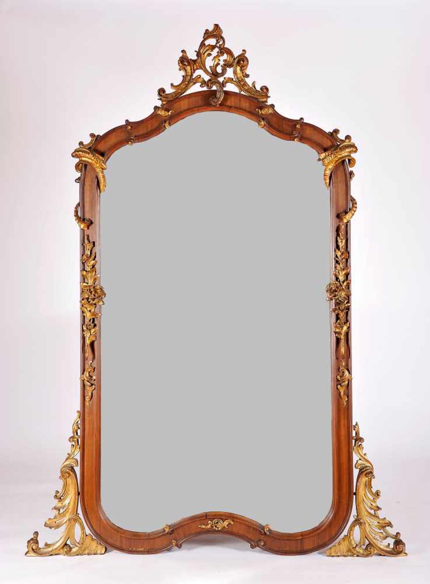 A Mirror, mahogany frame with gilt wood carvings "Vegetalist elements", bevelled mirror, Italian,