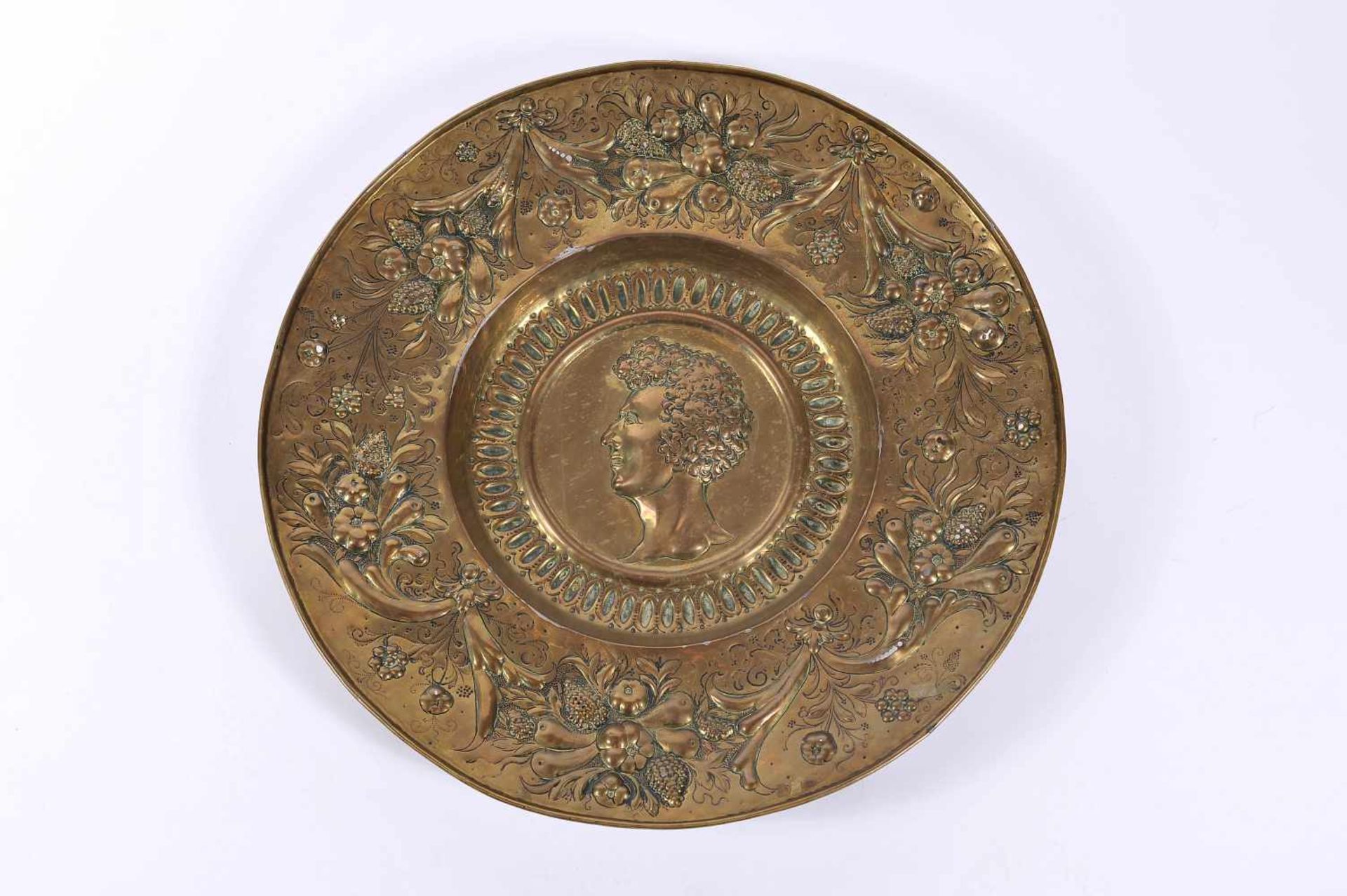 A Dish, gilt metal en relief "Male Effigy", rim en relief "Fruits", German, 19th C., small