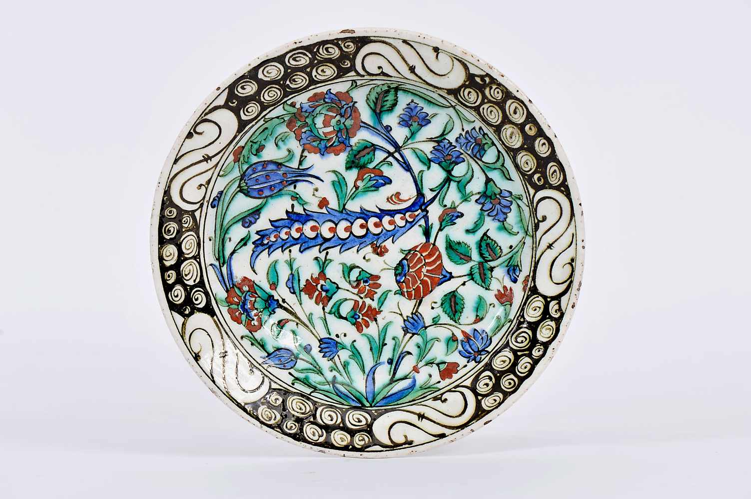 A Dish, faience, polychrome decoration "Flowers", the Isnik manner. Turkish, 19th C., chips, minor - Image 2 of 3