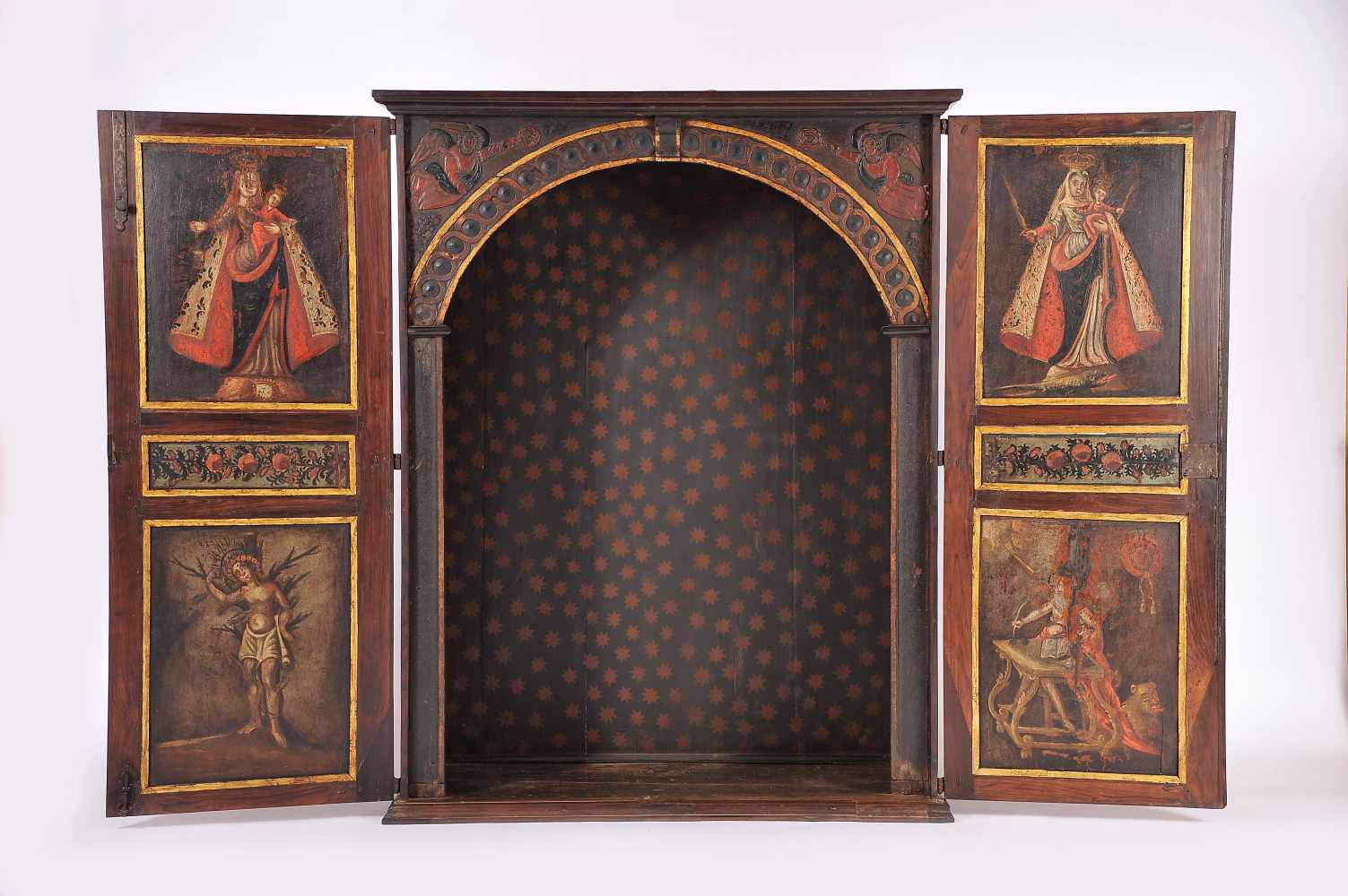 An Oratory, Brazilian rosewood, padded doors and sides, interior with carved and painted arch "