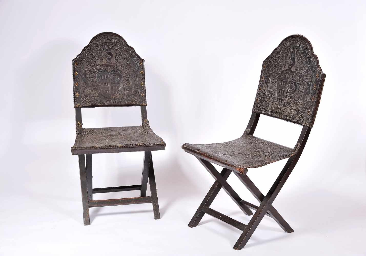 A Pair of Scissor Chairs, D. João V, King of Portugal (1706-1750), darkened chestnut, embossed