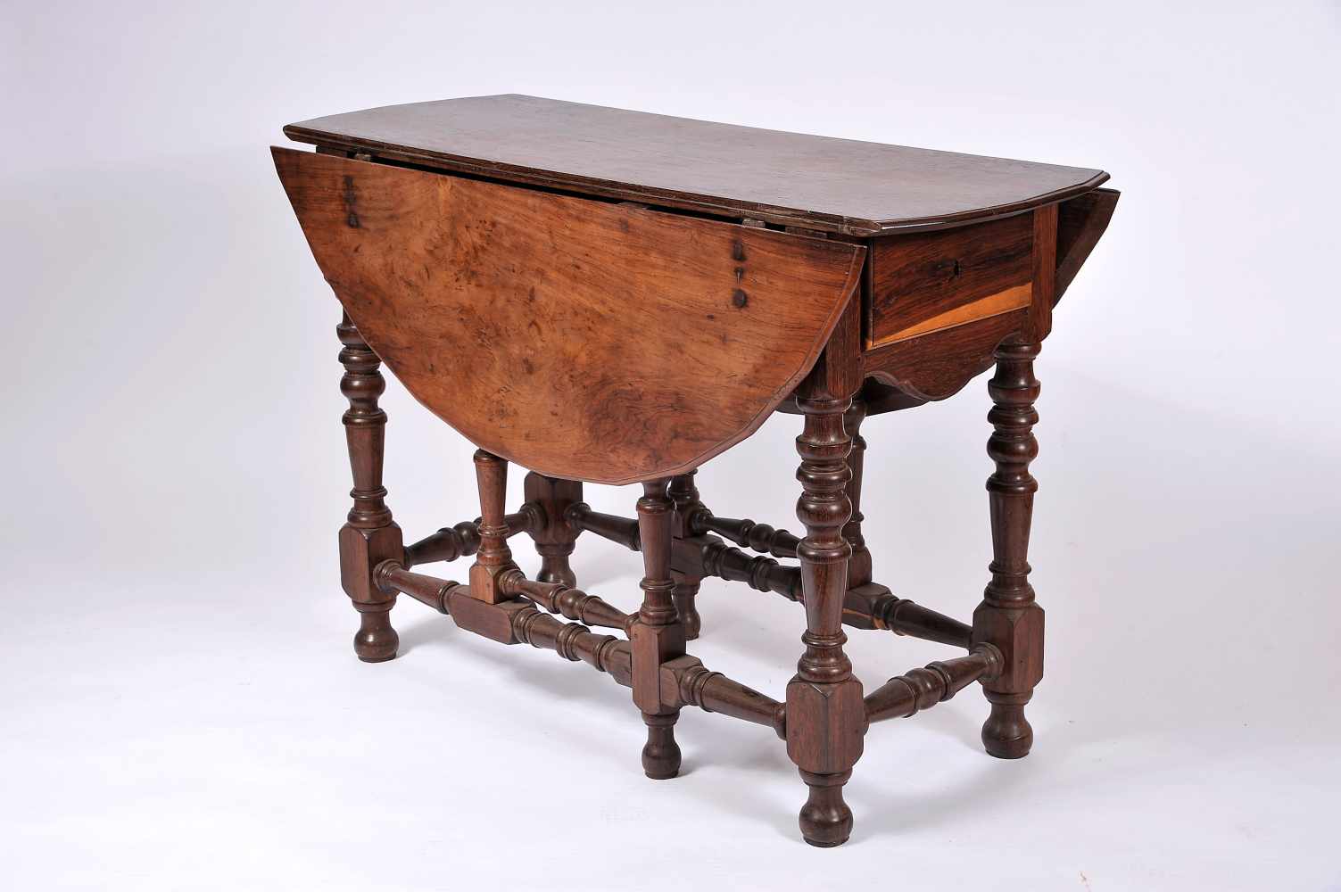 A Gate Leg Table with Two Drawers, Brazilian rosewood, multi-faceted edge top, turned legs and